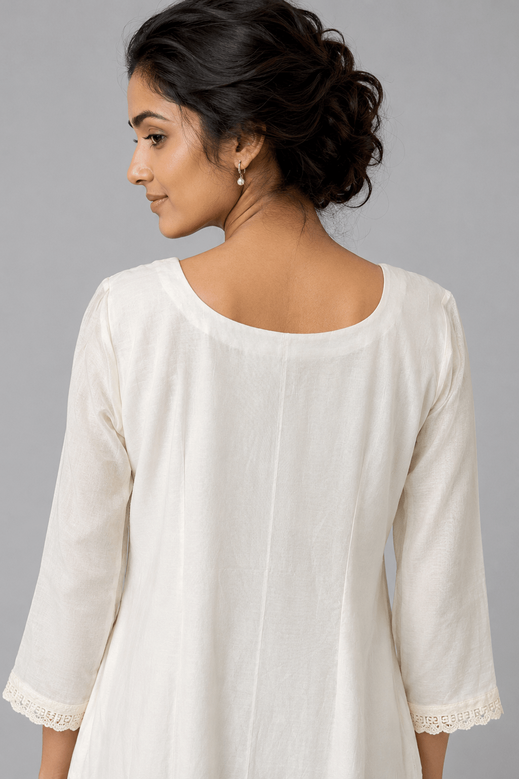 Ivory Zoya White Glass Chanderi Dress with floral embroidery and pleated detailing for festive wear back view