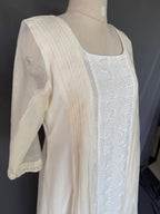 Ivory Zoya White Glass Chanderi Dress with floral embroidery and pleated detailing for festive wear close up side view