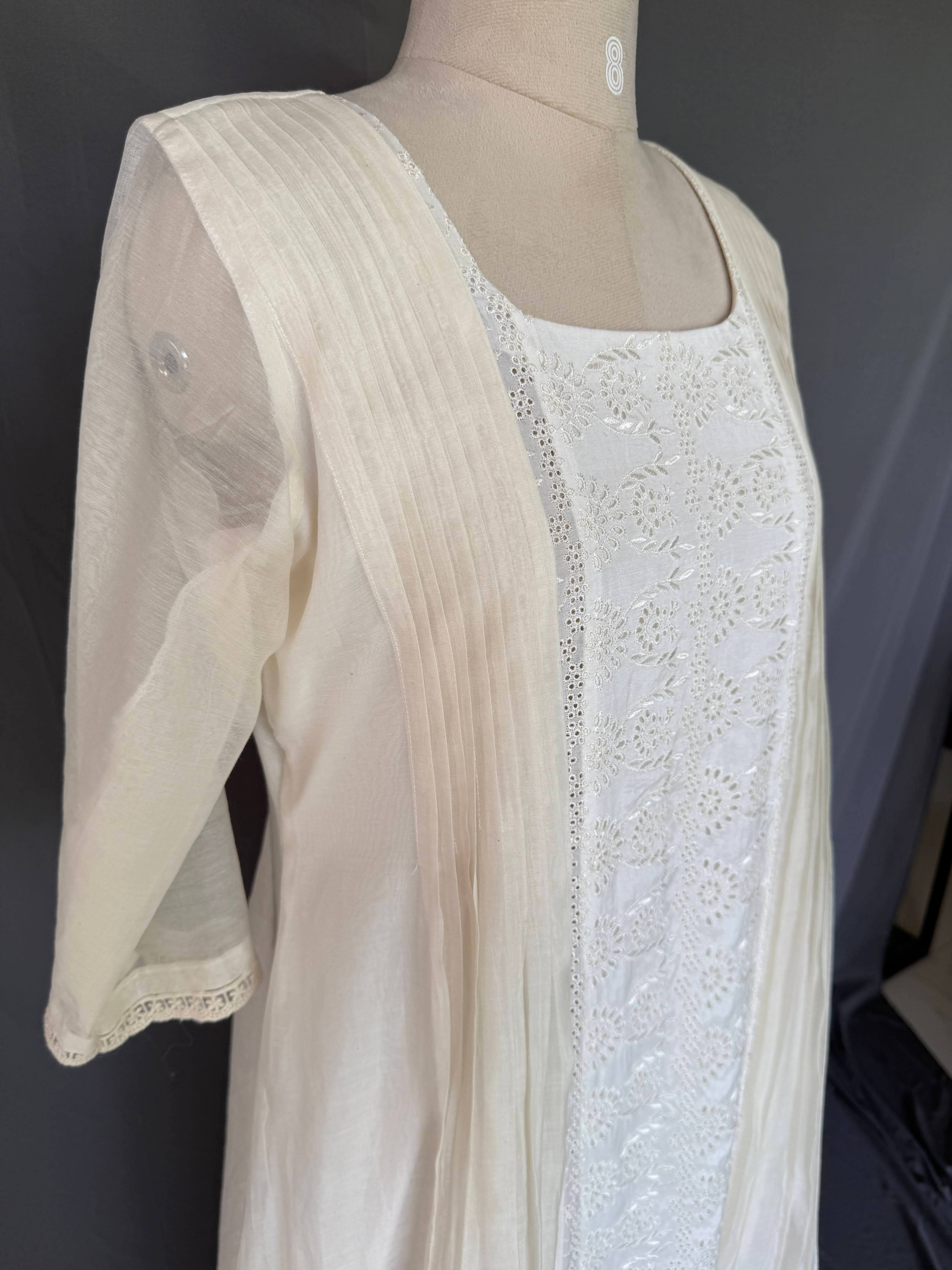 Ivory Zoya White Glass Chanderi Dress with floral embroidery and pleated detailing for festive wear close up side view